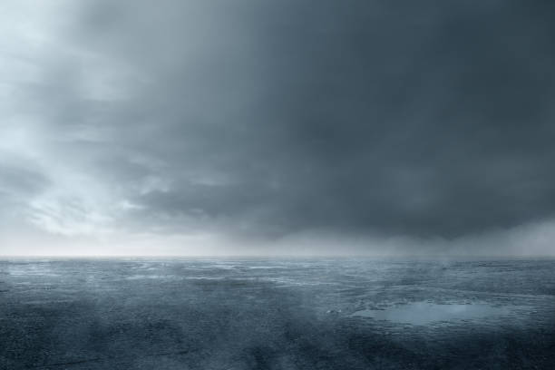 istock A wet, muddy field with cloudy and dark sky background 2176050152