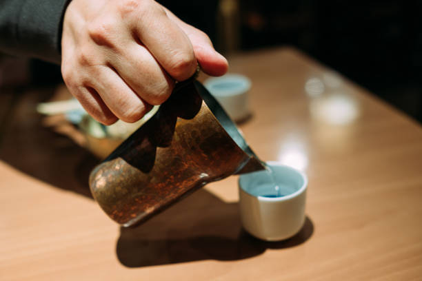 istock Image of pouring sake from a sake warmer into a sake cup 2176053115