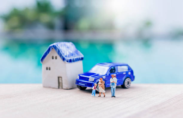 istock Miniature people with house and car model over blurred background 2176054731