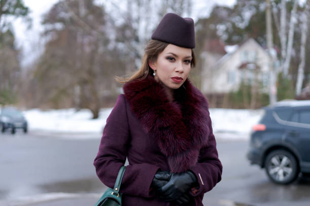 istock A woman wearing a red coat and hat 2176061237