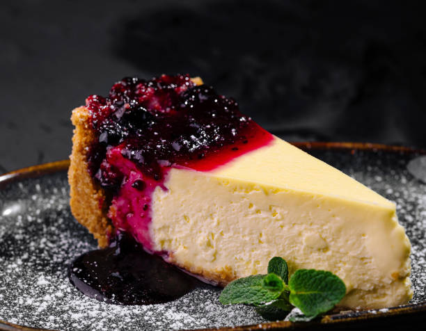 istock Gourmet cheesecake with berry compote on dark background 2176061567