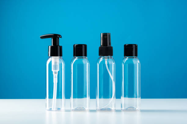 istock Clear plastic bottles with black caps arranged on a white surface against a bright blue background 2176061756