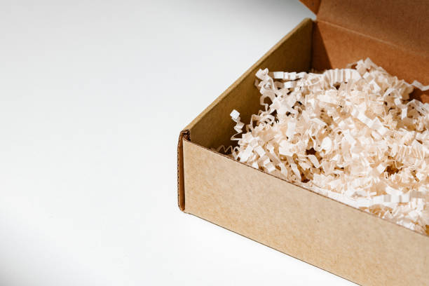 istock A simple brown gift box with natural filling sits elegantly on a light surface, capturing soft shadows 2176062342