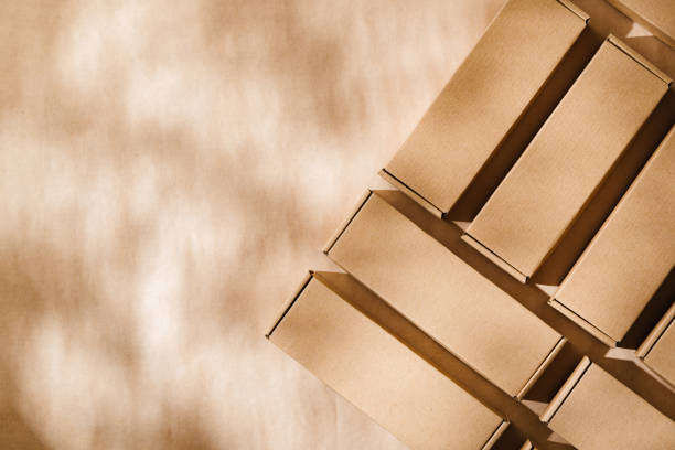 istock Brown cardboard boxes arranged on a neutral background in a warehouse setting during daylight hours 2176066183