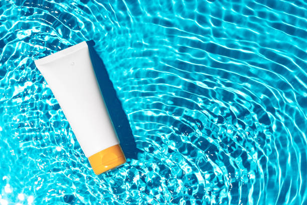 istock Sunscreen bottle floating in a clear blue swimming pool on a sunny day 2176066185