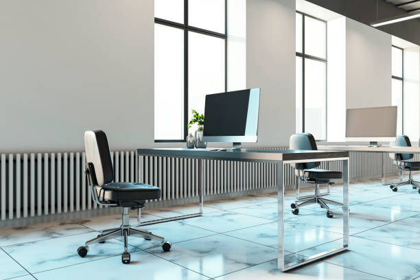 Modern office interior with empty desks and chairs on a marble floor, large windows in the background. Concept of corporate workspace. 3D Rendering