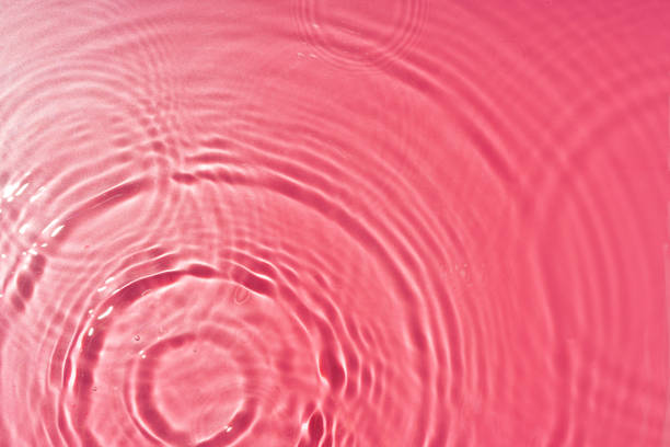 istock Ripples of light and color in a pink water surface reflecting mesmerizing patterns at midday 2176067331