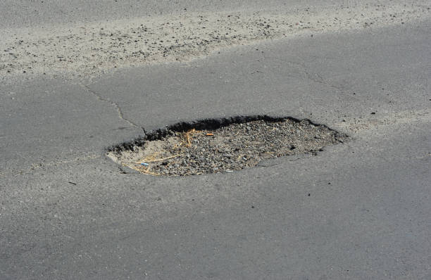 istock Road pit. Close up on asphalt road pothole need to repair. 2176067565