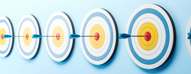 istock Multiple dartboards with arrows hitting the bullseye on a blue wall background. 3D Rendering 2176067615