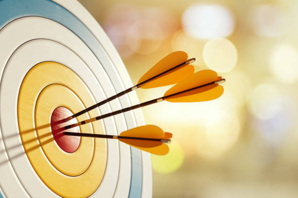 istock Three arrows hitting the bullseye on a dartboard with a blurred background. 3D Rendering 2176067689