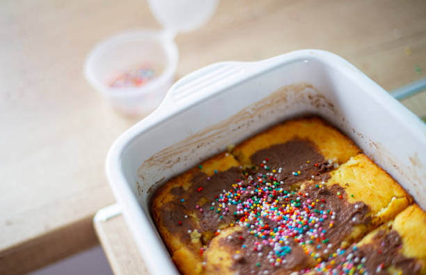 Sweet cake decorated with multi-colored balls in a white ceramic form. Breakfast casserole