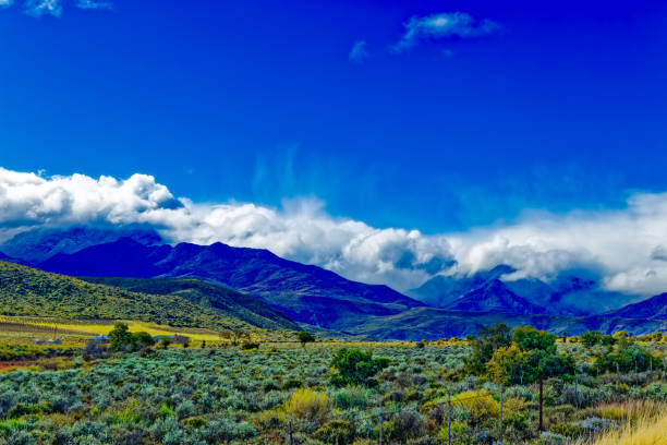 Landscape of Swartberg mountains in the Little Karoo with heavy cloud and rain after winter storms near Calitzdorp in the Western Cape, South Africa
