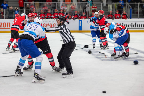 Referees Attempt to Break Up Multiple Fights in Hockey Game