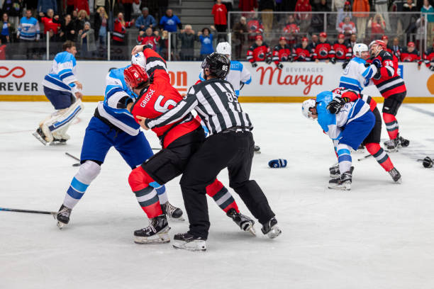 istock Ice hockey players fighting on rink 2176074475
