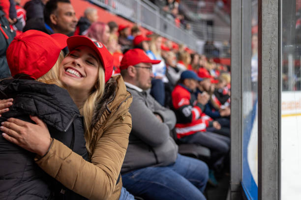 istock Warm Hug Between Fans at Ice Hockey Game 2176074579