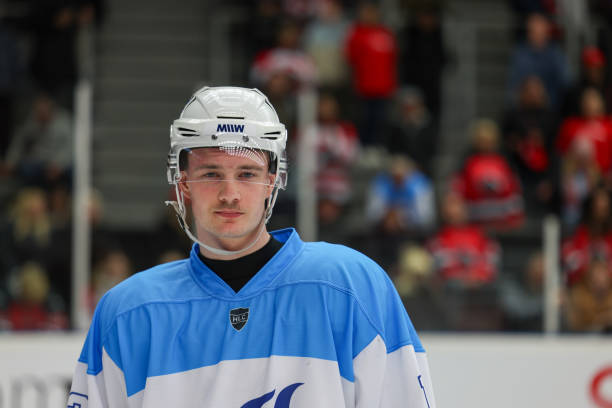 istock Focused Hockey Player in Blue Uniform 2176074612