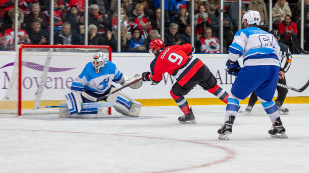 istock Hockey Goalkeeper Defending Against a Powerful Shot 2176074759