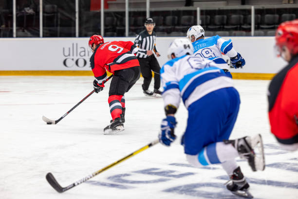 istock Intense Ice Hockey Play with Red Team Attacking 2176075313