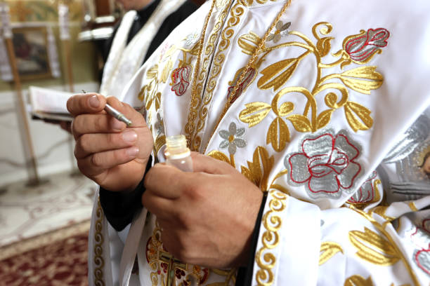 istock When performing the rite of baptism and anointing, priests use church objects. 2176075741