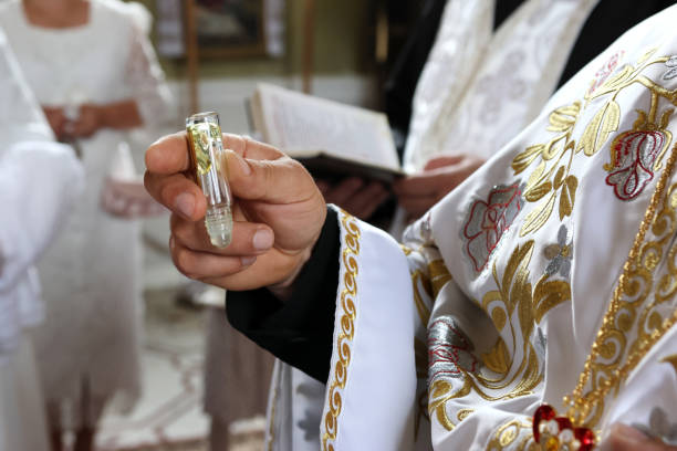 istock The priest performs the rite of baptism and anointing. 2176076271