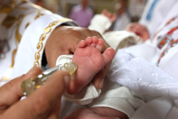 An orthodox priest christening a baby boy in an Orthodox church.