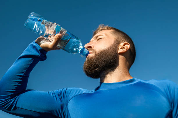 istock Happy Man Hydrating During Park Jog 2176080742