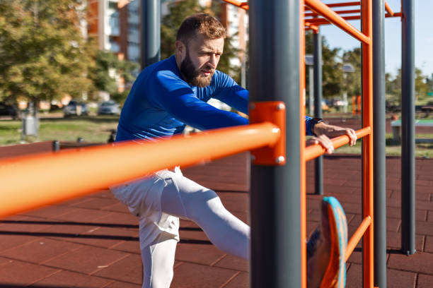 istock Young man in sportswear stretches 2176080781