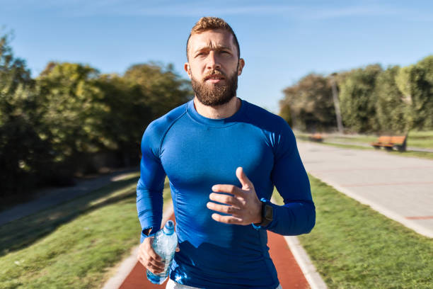 istock Active Young Man Enjoying a Run in the Park 2176080853