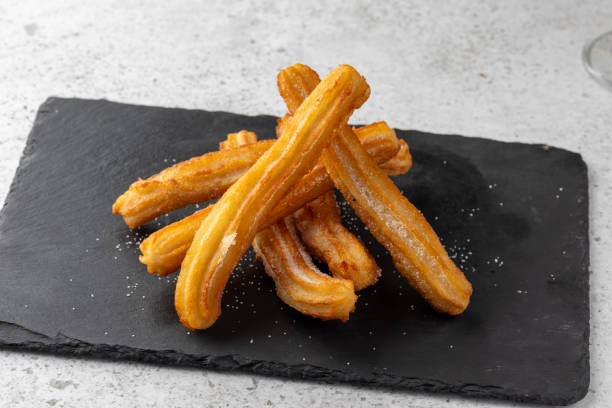 istock Hot chocolate with whipped cream and churros delight. 2176081838