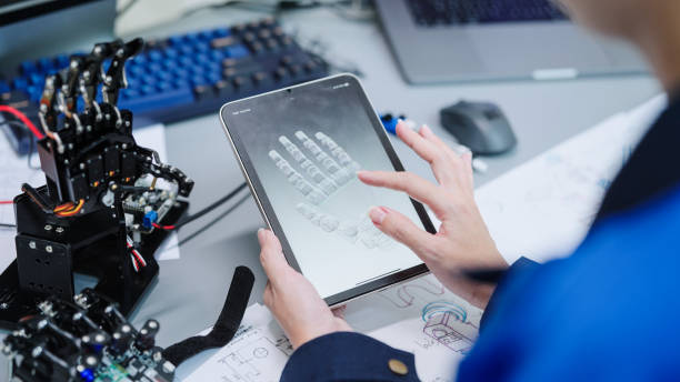 Close up engineer developer working 3D robotics arm model prototype on a digital tablet testing program mechanical software components hand movement Close up engineer developer working 3D robotics arm model prototype on a digital tablet testing program mechanical software components hand movement medical technology stock pictures, royalty-free photos & images