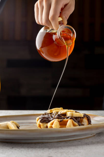 istock Delicious waffle dessert with fruit and sauce drizzle 2176084054