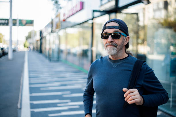 istock Older man gesturing on city street 2176087091