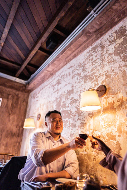 istock Mature man toasting wine with wife during dinner at restaurant 2176094399