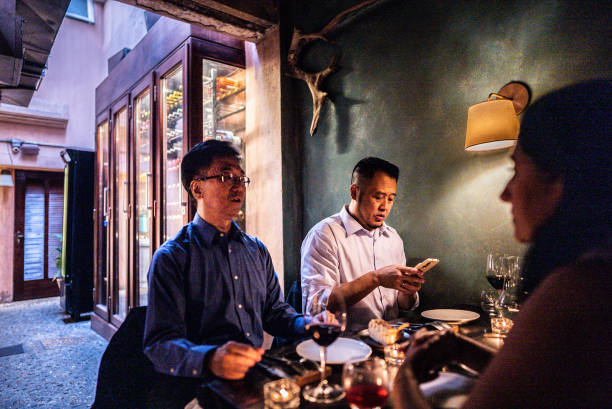 istock Businessmen talking during dinner at restaurant 2176094413