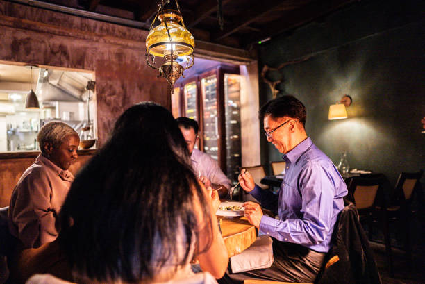 istock Coworkers eating during dinner at restaurant 2176094453