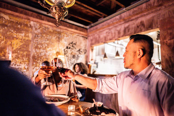 istock Coworkers toasting wine during dinner at restaurant 2176094499