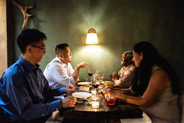 istock Coworkers talking during dinner at restaurant 2176094782