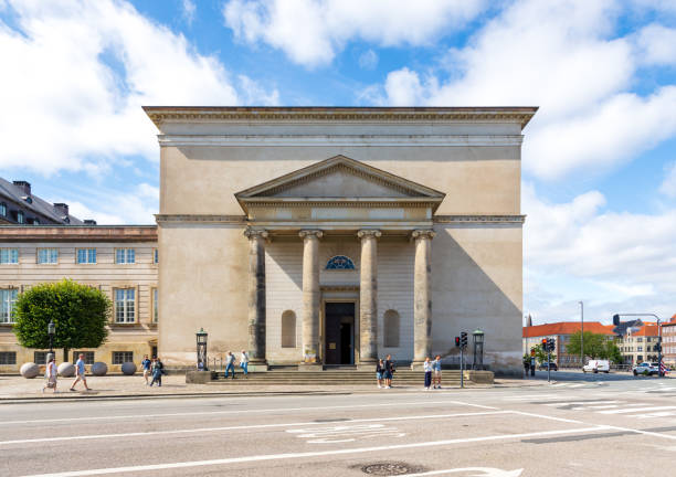Copenhagen, Denmark - July 18, 2024: Facade with portico of the Christiansborg Palace Chapel in a neo-classical style, inaugurated in 1997 after its reconstruction following its destruction by fire.