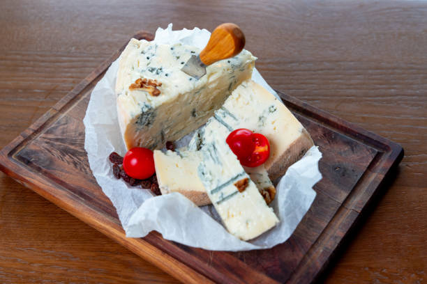 Gorgonzola cheese served on wooden board with cherry tomato in fine dining