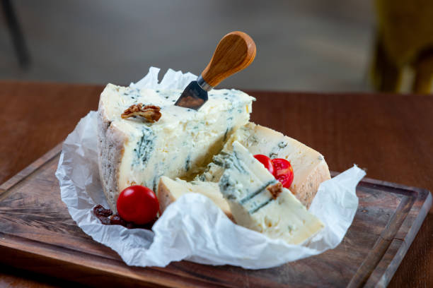 Gorgonzola cheese served on wooden board with cherry tomato in fine dining