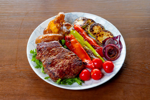 Roast meat with baked potato, grilled zucchini and paprika in fine dining