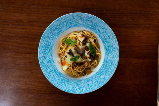 Spaghetti with black truffles and grana cheese served in fine dining
