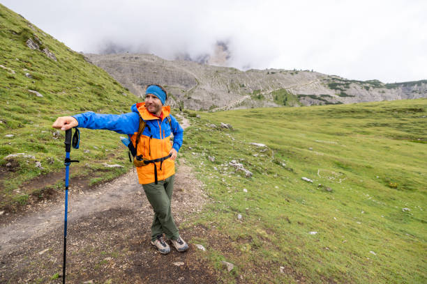istock Hiker Pausing on Mountain Trail with Trekking Pole 2176101828