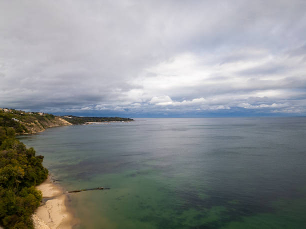 istock A serene coastal landscape with a sandy beach, lush green cliffs, and calm waters stretching into the horizon under a cloudy sky. Perfect for travel, nature, or coastal themes. Varna, Bulgaria 2176102158