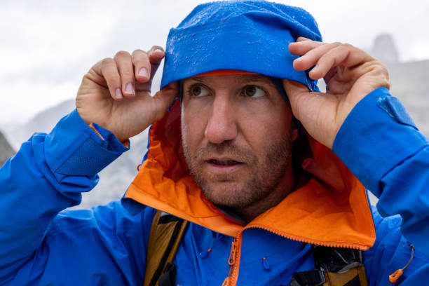 istock Male hiker under the rain gearing up 2176102245