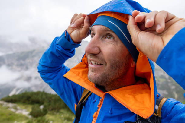 istock Smiling Hiker in Rain Gear with Scenic Mountain View 2176102300