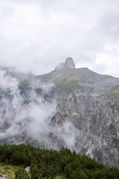istock Misty Alpine Valley with Rugged Mountain Peaks 2176102640