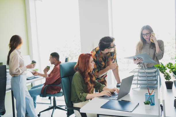 istock Photo of group five young corporate workers talk networking desktop workstation office business center indoors 2176102672