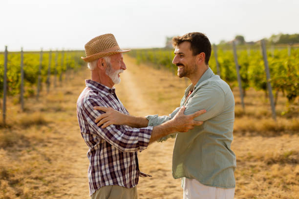 istock Heartfelt conversation between two generations in a sunlit vineyard during late afternoon harvest season 2176102917