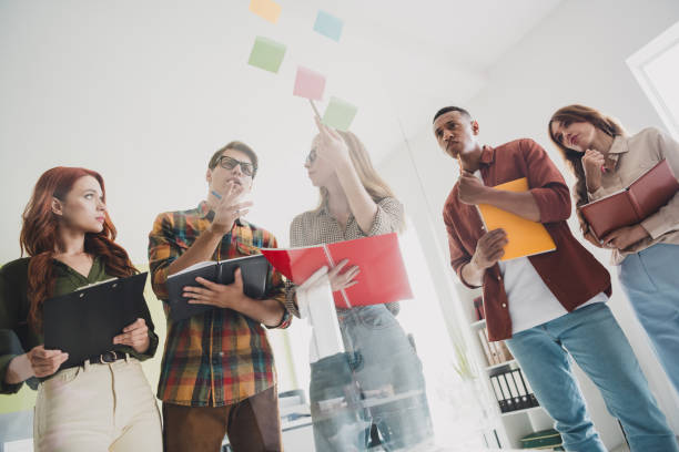 istock Photo of corporate colleagues concentrated on discussion about using stickers before release the genius business plan indoors office 2176103121